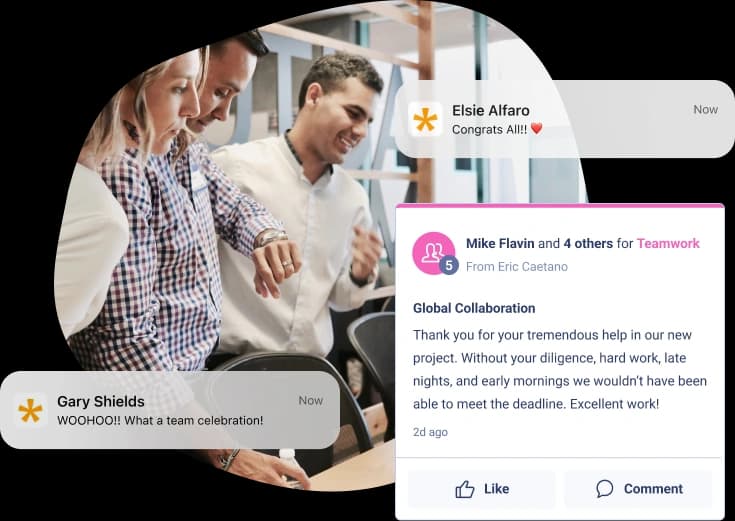 A group of three people is collaborating at a table, focusing on a project. Above them, notifications from Workhuman display messages of congratulations and teamwork. One notification reads "Congrats All!!" from Elsie Alfaro, while another from Mike Flavin and others expresses gratitude for the team's hard work on a project that met the deadline. A comment from Gary Shields celebrates the teamwork with "WOOHOO!! What a team celebration!" The atmosphere is positive and collaborative.