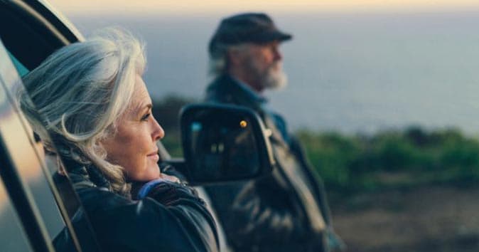 woman with gray hair gazing wistfully