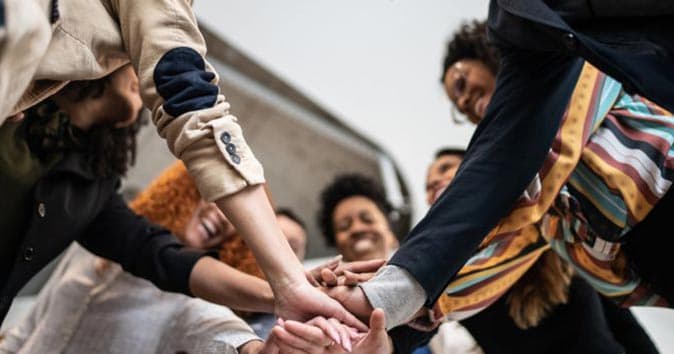 employees in group handshake