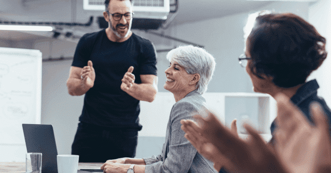 Team clapping for an employee as an expression of appreciation and encouragement